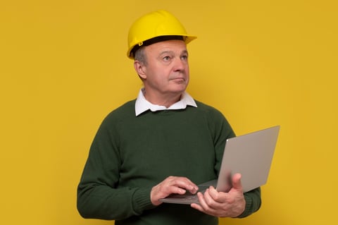 senior foreman holding laptop